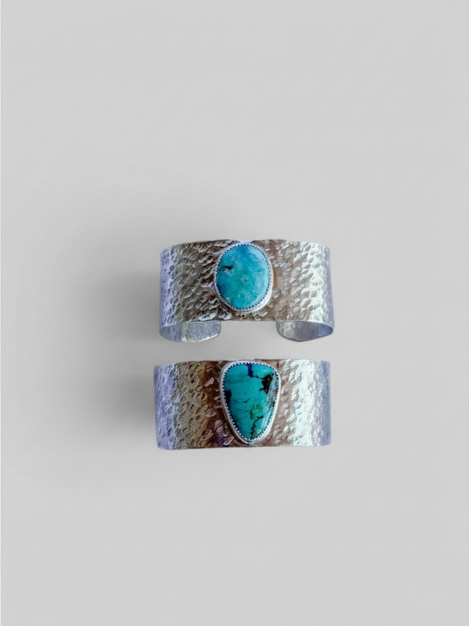Wooten & Co. turquoise and hammered sterling silver cuff bracelets featuring oval and teardrop genuine stones.