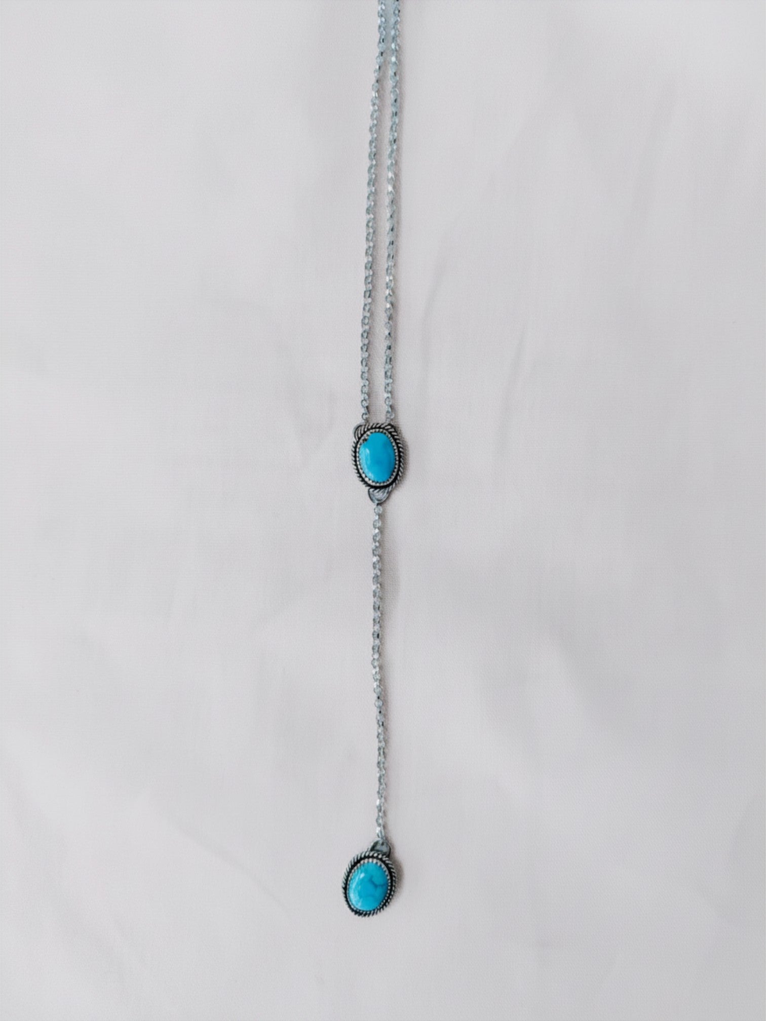 Wooten & Co. Paducah lariat necklace featuring two genuine turquoise stones set in sterling silver on a delicate chain.