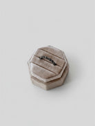 Wooten & Co. Kennard sterling silver twist ring displayed in a beige velvet hexagonal ring box