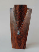 Wooten & Co. Blanco Blue Pietersite necklace with sterling silver setting and blue enamel bead accents on display