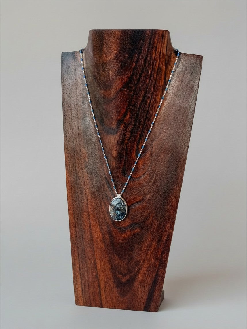 Wooten & Co. Blanco Blue Pietersite necklace with sterling silver setting and blue enamel bead accents on display