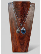 Wooten & Co. Blanco Blue Pietersite necklace featuring sterling silver chains with blue enamel beads on a wood display.