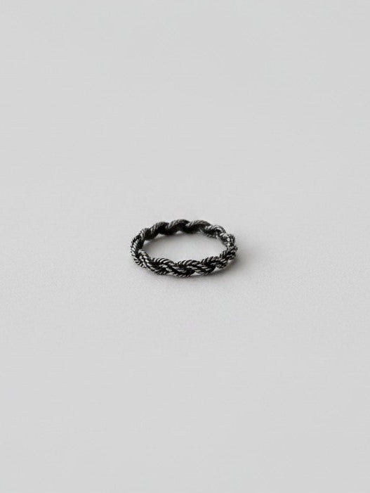 Wooten & Co. Kennard sterling silver twist ring with a sculptural intertwined band design on a neutral background.
