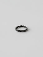Wooten & Co. Kennard sterling silver twist ring with a sculptural intertwined band design on a neutral background.