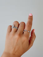 Wooten & Co. Nazareth adjustable sterling silver twist ring featuring mother of pearl stones on a finger