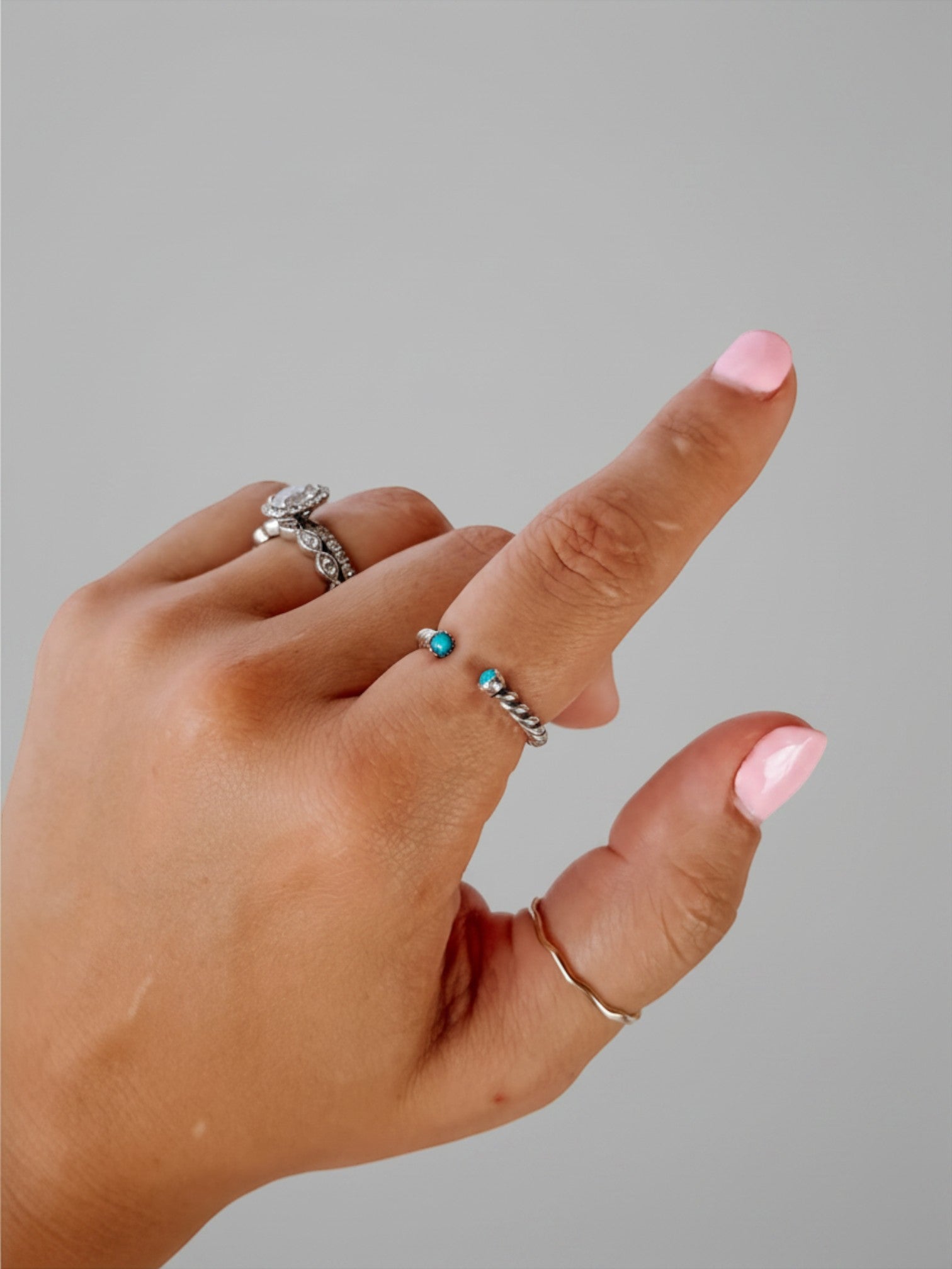 Wooten & Co. Nazareth turquoise twist ring in sterling silver worn on a finger with a twisted band design