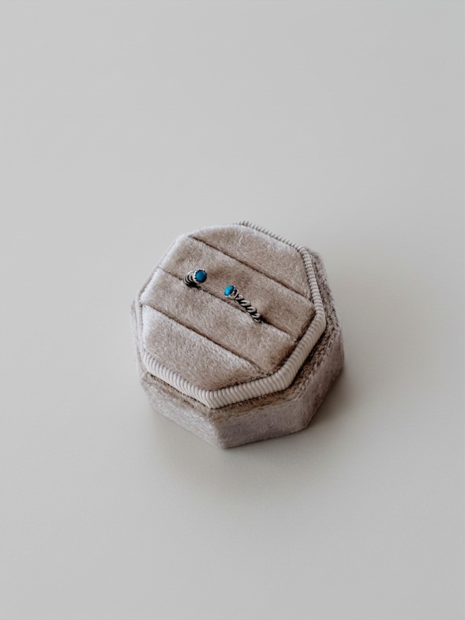 Wooten & Co. Nazareth turquoise twist ring in sterling silver with an adjustable open band design in a velvet box.