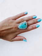 Wooten & Co. Palmer turquoise statement ring in sterling silver with intricate linear texturing worn on a hand