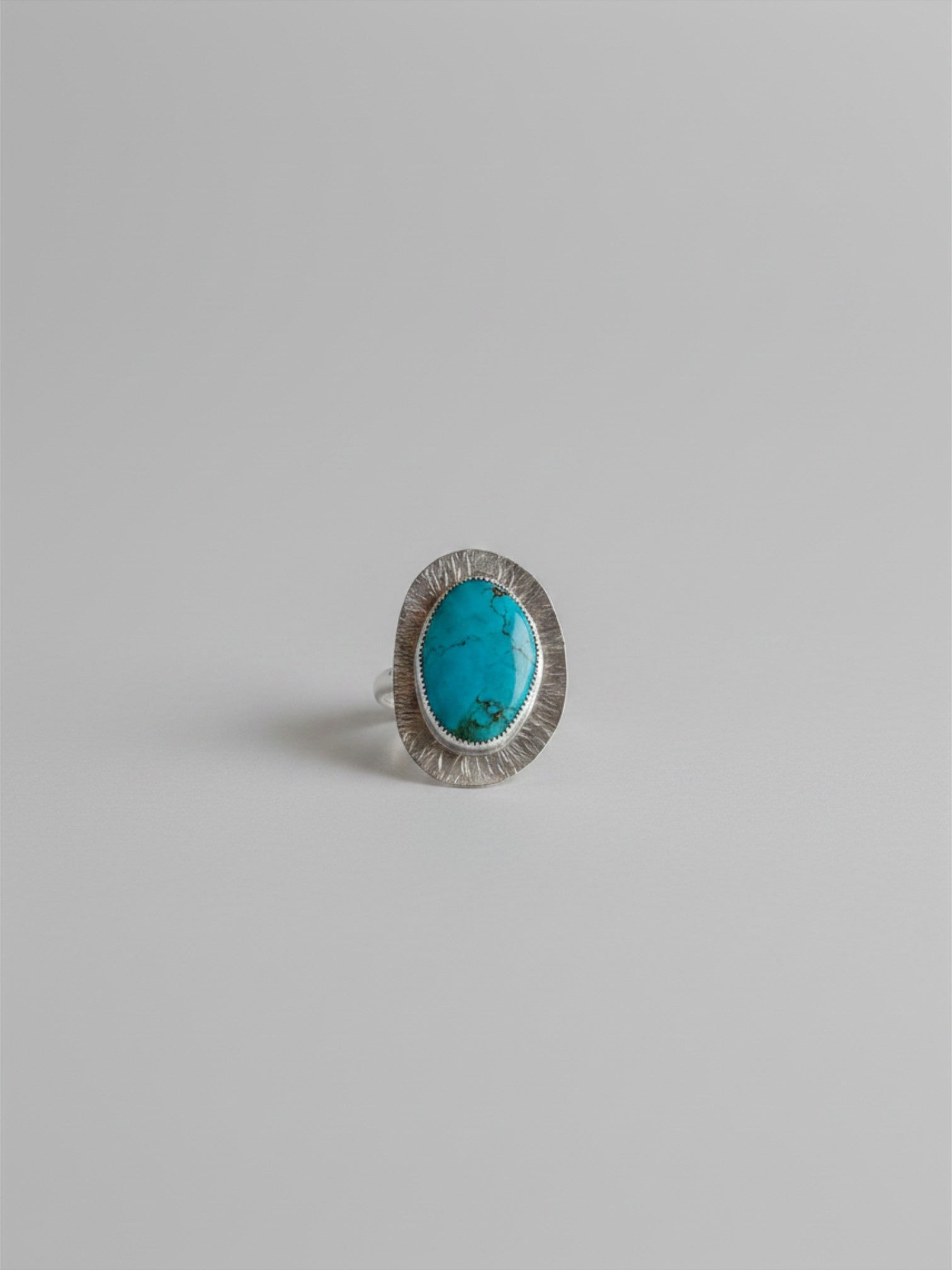 Wooten & Co. Palmer turquoise ring featuring a genuine oval stone in a textured sterling silver setting.