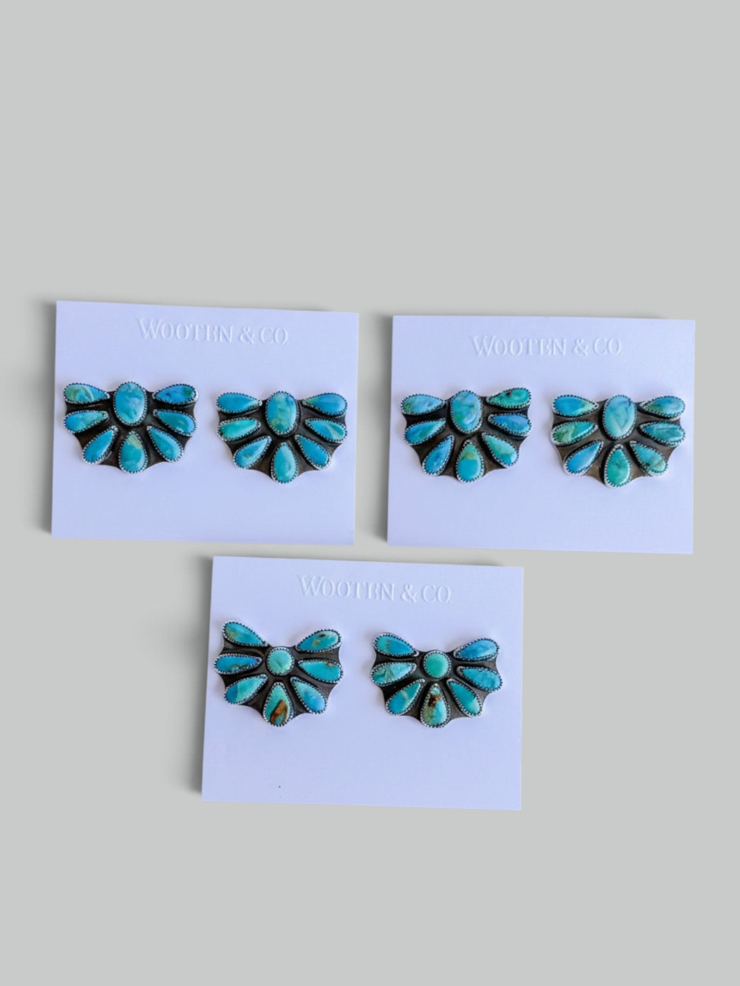 Wooten & Co. sterling silver cluster earrings featuring genuine turquoise stones in a Southwestern fan design.