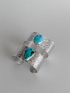 Wooten & Co. Stowell turquoise cuff bracelets featuring hammered sterling silver and genuine turquoise stones.