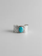 Wooten & Co. Stowell turquoise cuff bracelet featuring a genuine oval turquoise stone set in hammered sterling silver.