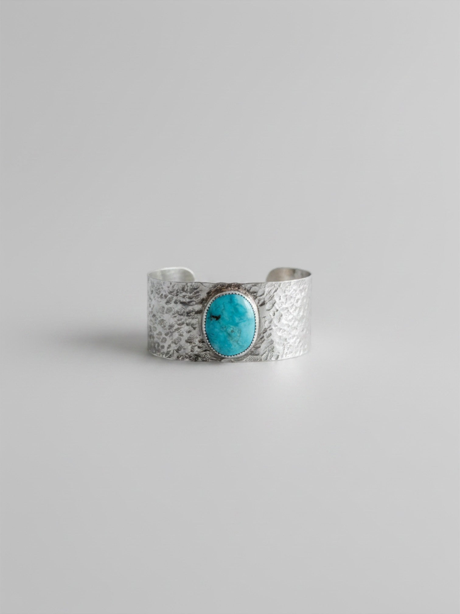 Wooten & Co. Stowell turquoise cuff bracelet featuring a genuine oval turquoise stone set in hammered sterling silver.