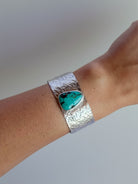 Wooten & Co. Stowell turquoise cuff bracelet featuring a wide hammered sterling silver band on a wrist