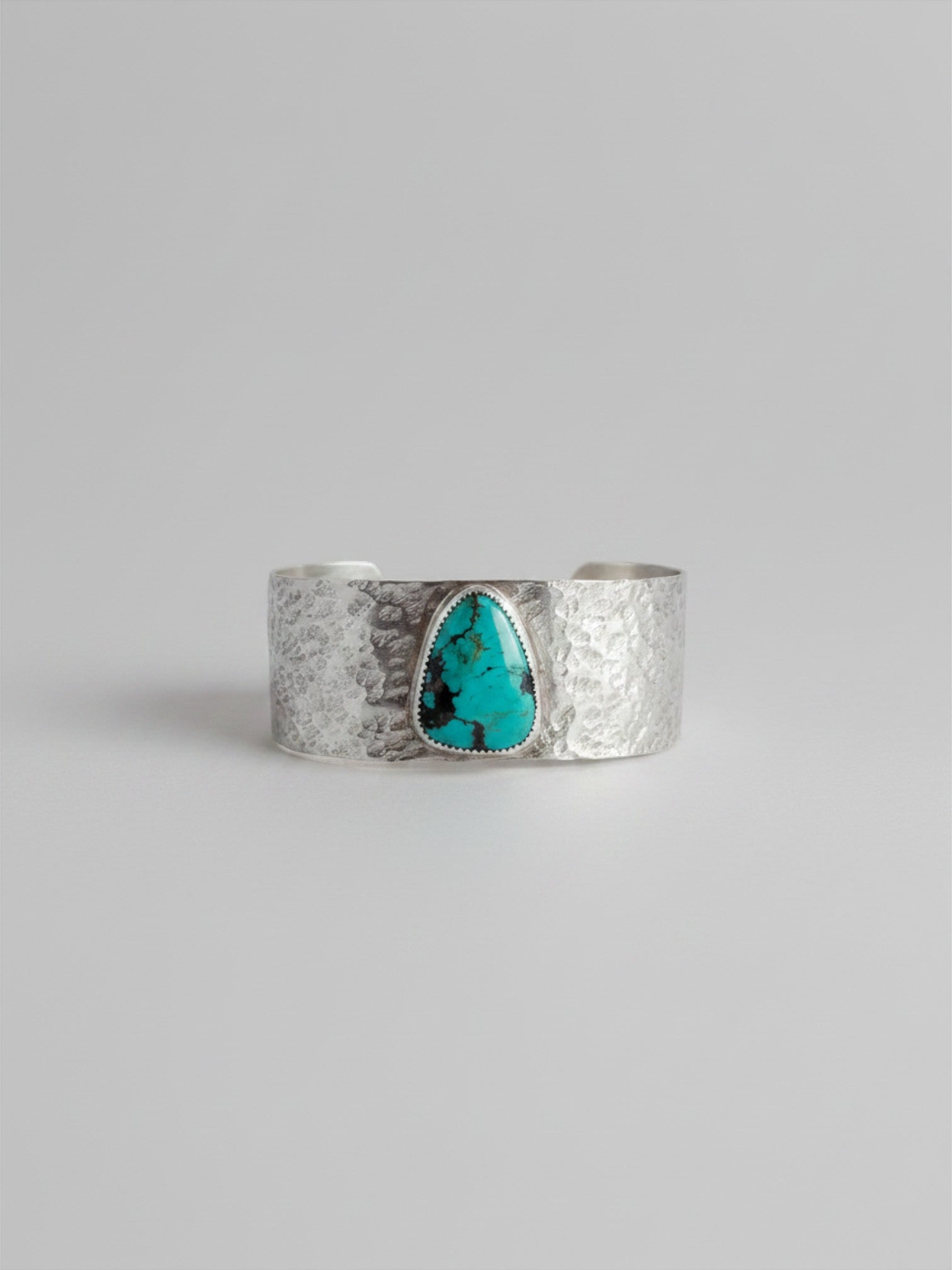 Wooten & Co. Stowell turquoise cuff bracelet featuring a hammered sterling silver band and a genuine turquoise stone.